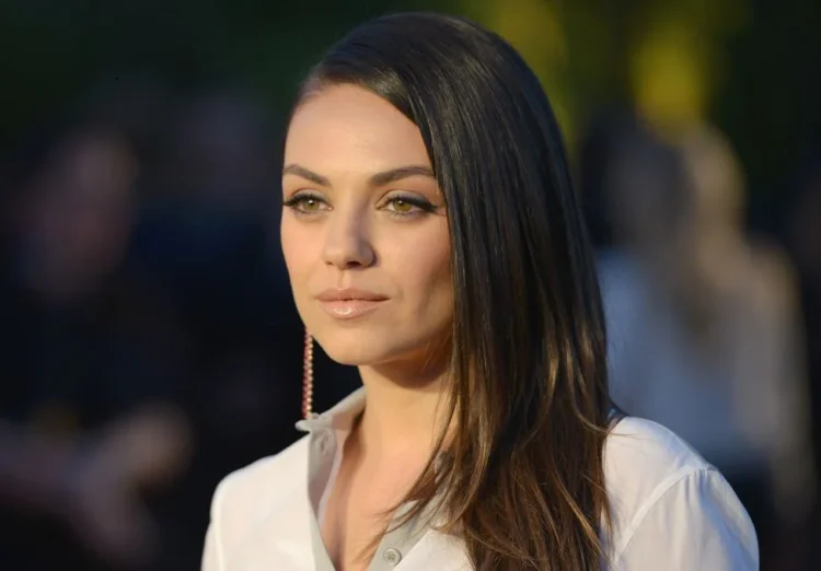 Mila Kunis on the red carpet, symbolizing her success in Hollywood.